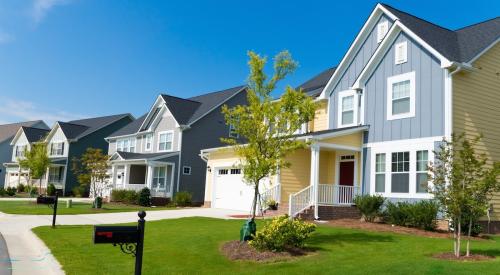 A row of new-construction homes in a residential neighborhood