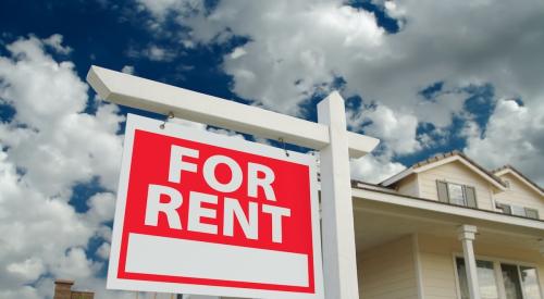 A single-family home with a "For Rent" sign in the front yard