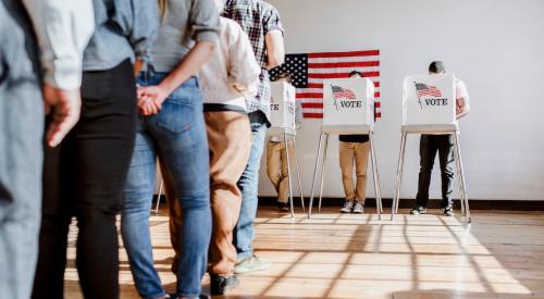 Voters line up to use voting booth