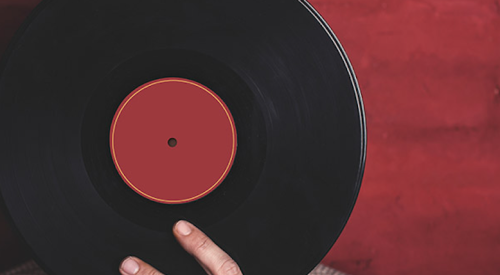 Man holding record in front of face