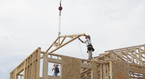 fall protection being used by construction crew placing roof truss