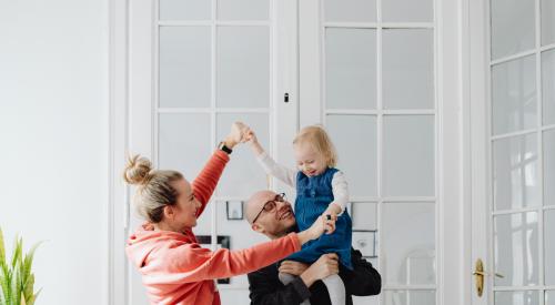 Couple with baby in clean house