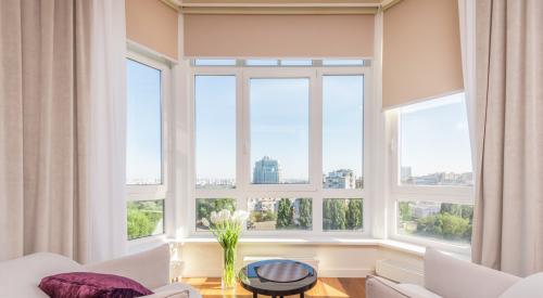 Naturally lit living room in high-rise building with city view