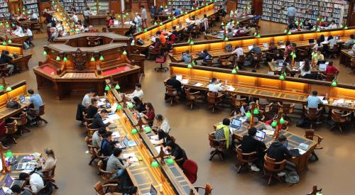 University library with rows of students working on laptops