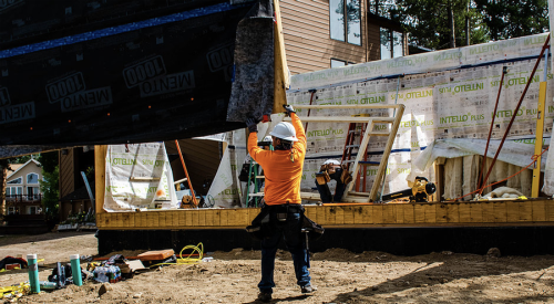 home construction placing wall panel 