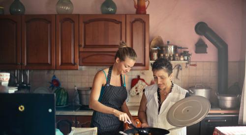 Mother and daughter cooking in home