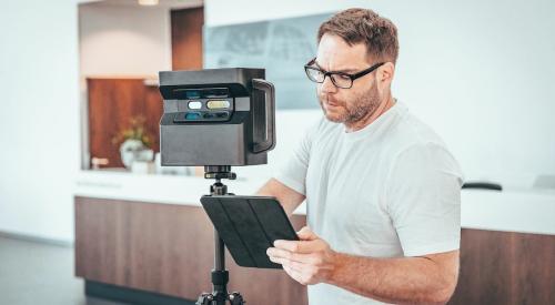 Person making 3D scan of room interior