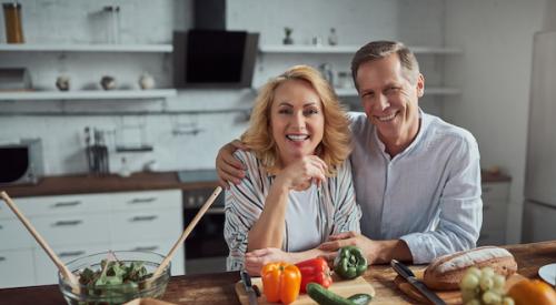 55 year old couple happy in the kitchen