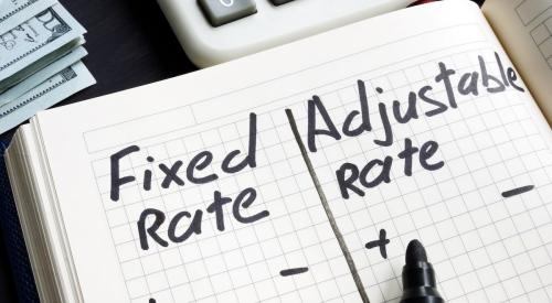 Person writing pros and cons of fixed interest rate and adjustable rate