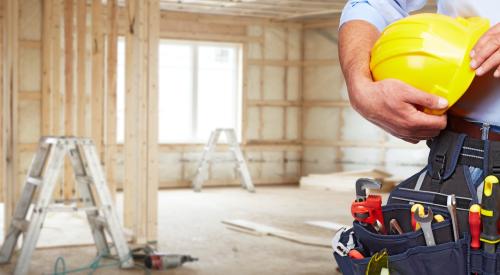 home builder holding hard hat