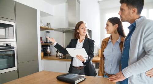 Couple with realtor viewing home