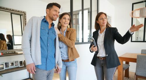 Prospective buyers touring home