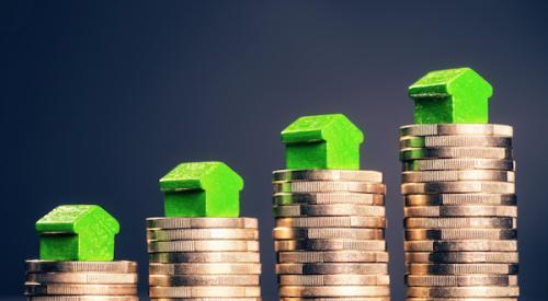 House figurines atop growing towers of coins