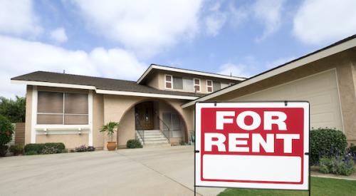 Home in background with For Rent sign in forefront