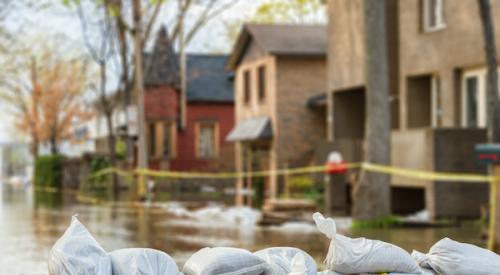 Flood protection sandbags with homes in back