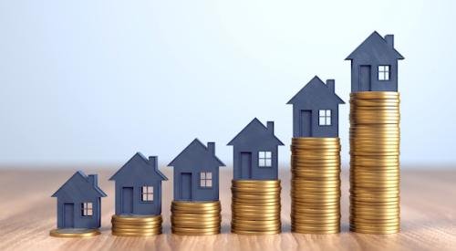 House figurines sitting atop rising coin towers