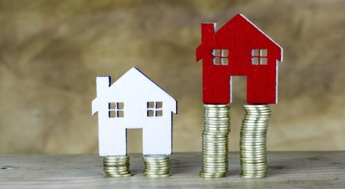 Two home figurines on stacked coins