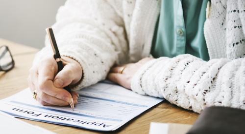 Woman's hands filling out application form