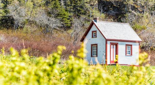 Tiny house in field