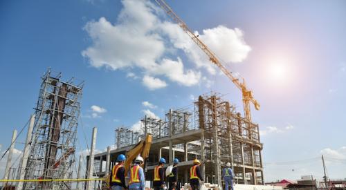 Group of construction workers walking to building site