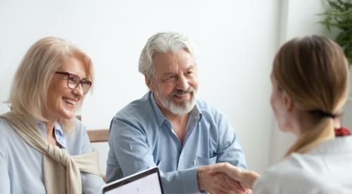 Older couple with real estate broker