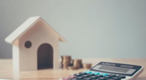 Calculator and house figurine