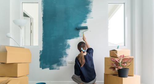 Woman painting wall