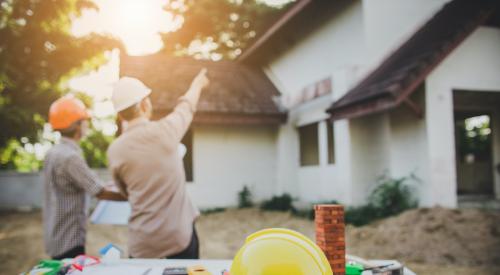 home builders pointing at house