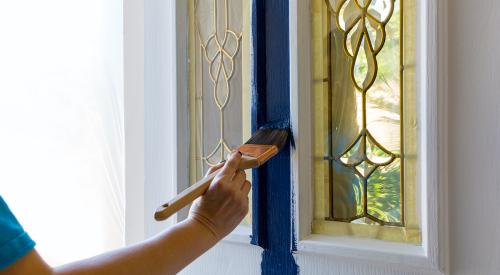 Person painting a front door