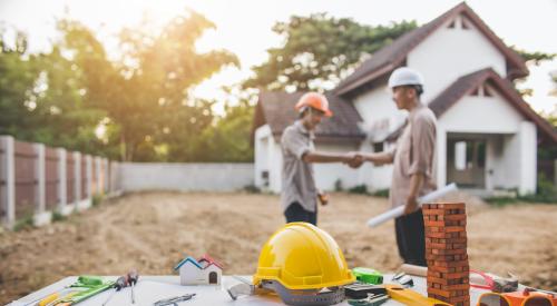 Builder and engineer shaking hands