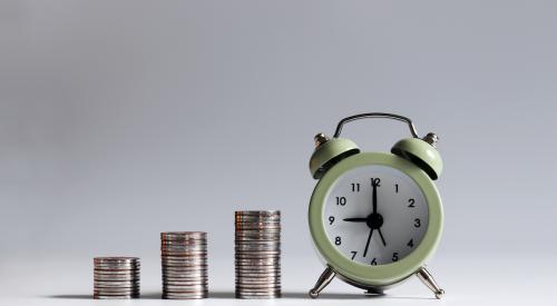 Clock and stacks of coins