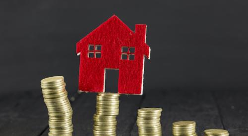 House balancing on top of coin stacks