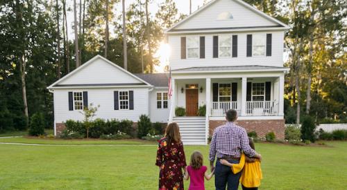 Family of four looking at a house