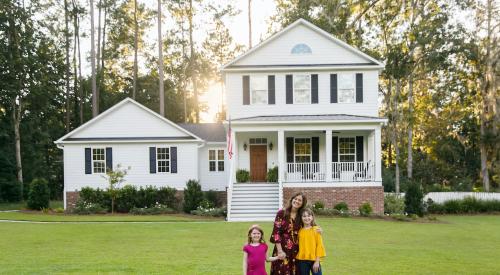 Family in front of new home