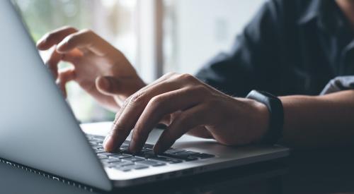 Person typing on computer