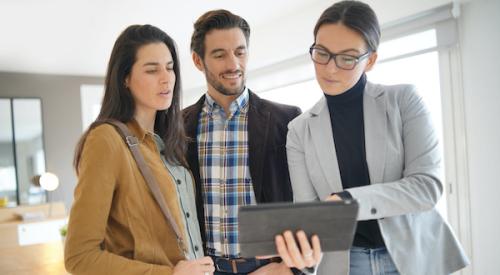 Couple viewing house with real estate agent