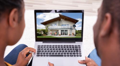 Couple looking at a house on laptop