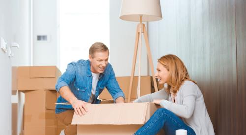 Couple packing moving boxes