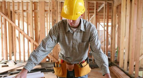 Builder measuring OSB