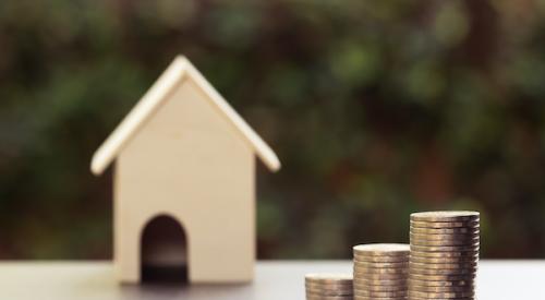 House figurine with rising coin stack