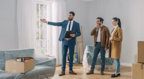 Realtor showing a couple around a house for sale