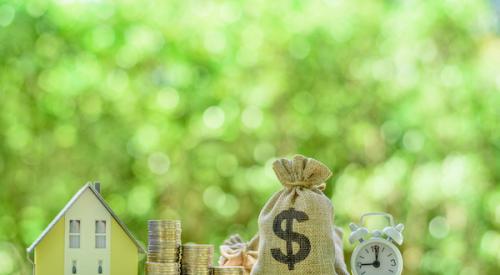 Home figurine next to stacked coins, money bag, and clock