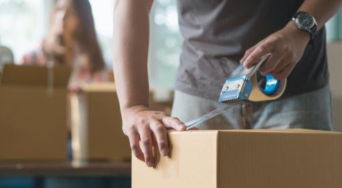 Man taping up moving box