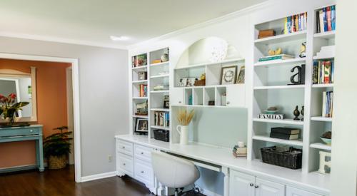 Home office with bookshelves spanning the wall