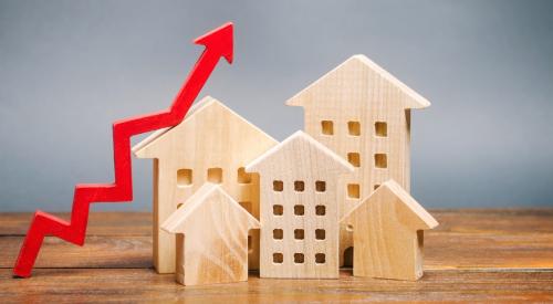 A red arrow points up above wooden houses.