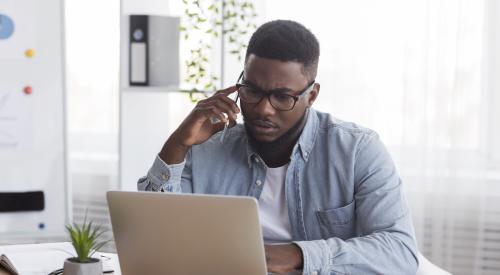 person on phone and laptop