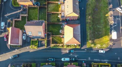 Aerial view of suburb with houses and lawns