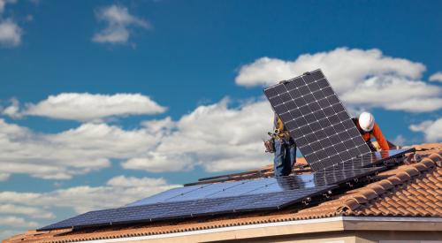 Workers installing solar panels