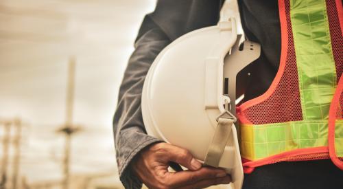 Builder holding hard hat