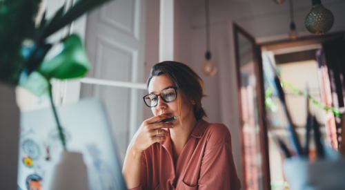 Woman working at desk at laptop